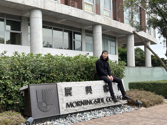 Jun Sitting on Morningside Sign