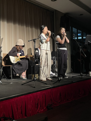 Two singers and a guitarist on stage