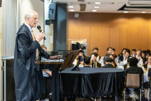 College Master Professor Nick Rawlins delivering opening address.