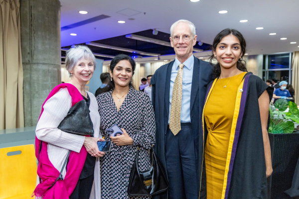 College Master Professor Nick Rawlins and the Hon. Lalla Ward taking photo with a student and her mother.