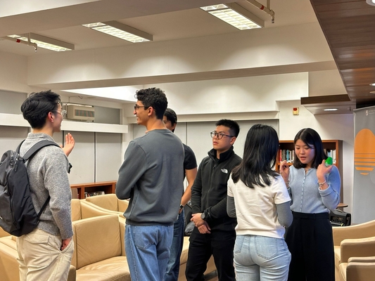 Students speaking with the alumni after the talk.