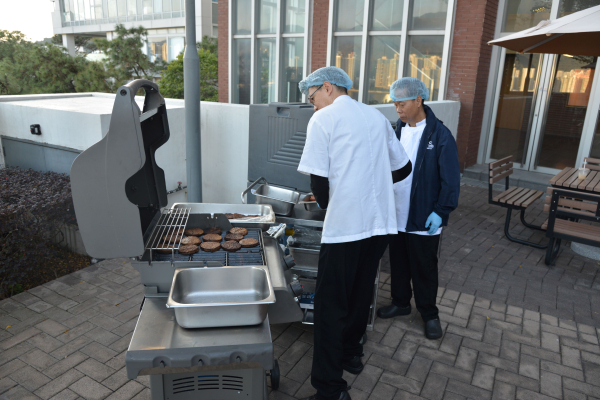 Catering team prepares the grill.