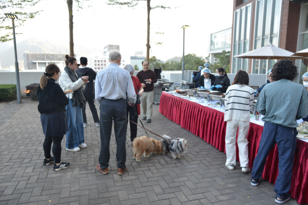 College staff gather near the buffet.