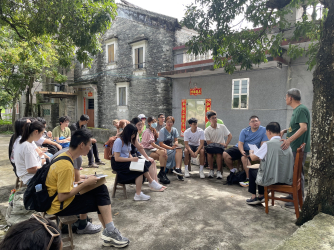 Students speaking to the owner of a diaolou