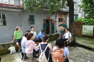 Students speaking to the owner of a diaolou