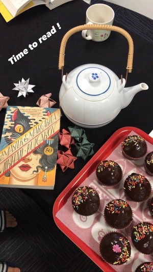 Teacup, book and cupcakes